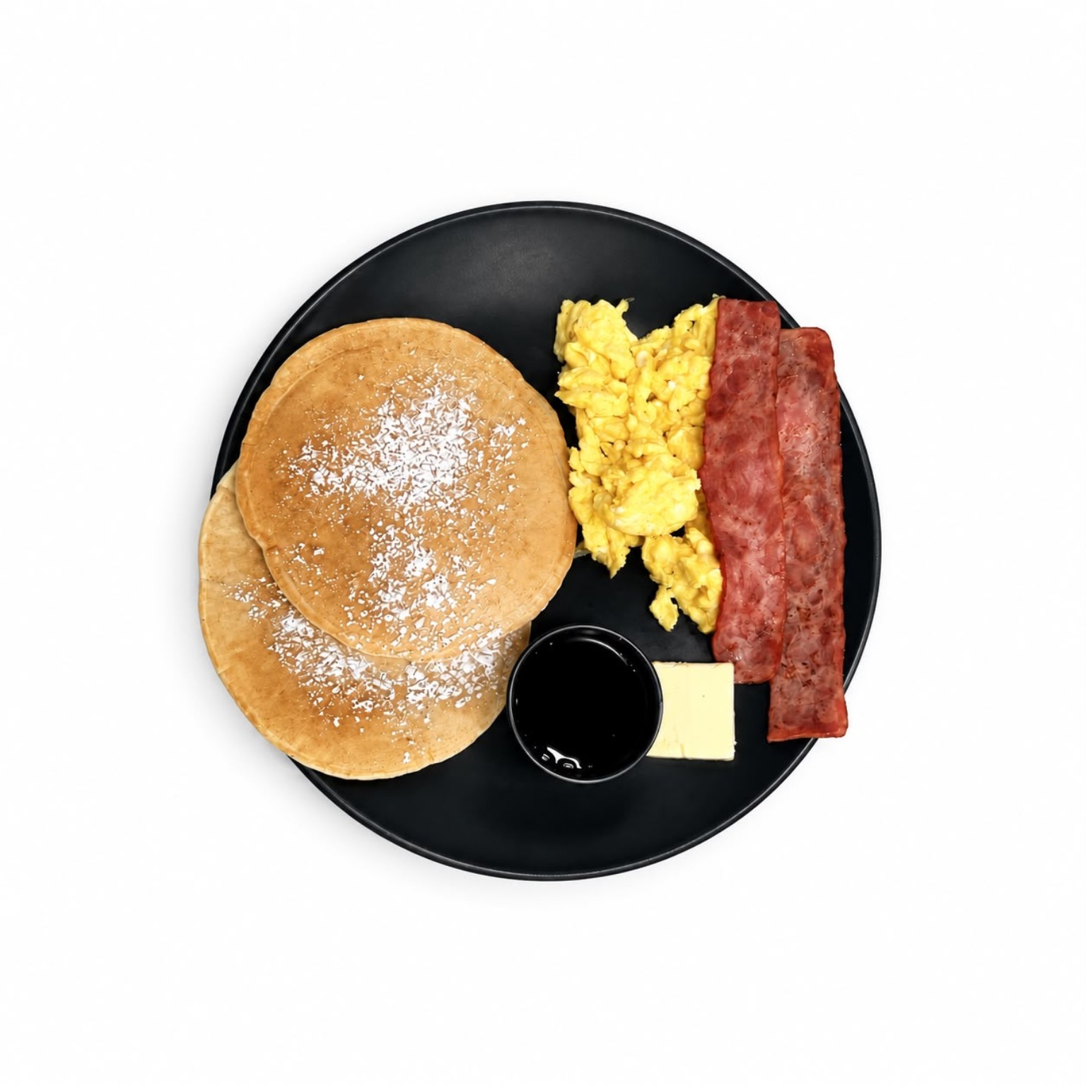 Breakfast with pancakes, eggs, and bacon